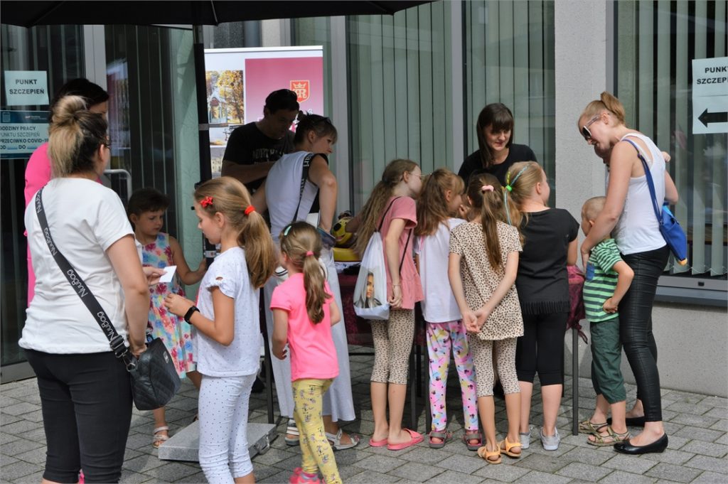 Dzieci i rodzice stoją przed stanowiskeim CITIKU na tarasie JDK.