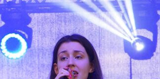 Sukcesy Karoliny Polak na Ogólnopolskich Festiwalach Młoda artystka: Karolina Polak, śpiewa do mikrofonu. Ubrana jest w błękitną, letnią, zwiewną sukienkę.