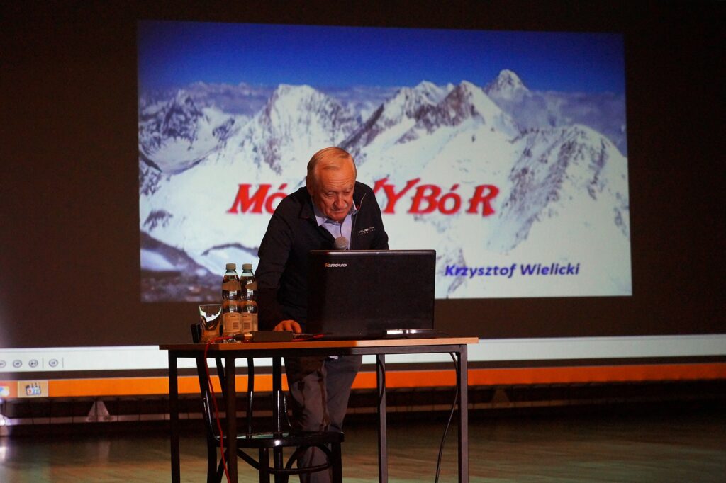 Krzysztof Wielicki na scenie. Alpinista opowiada o swoich górskich przygodach.
