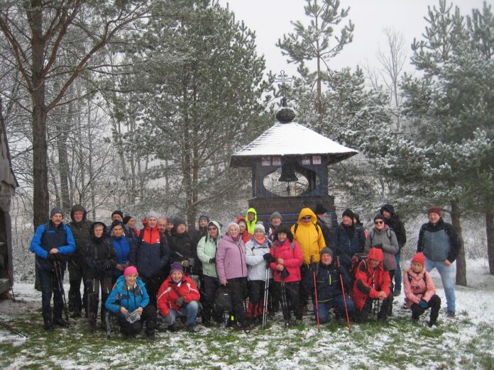 Beskid Dukielski - Smereczne grupa na tle dzwonnicy Grupa turystów przy dzwonnicy.