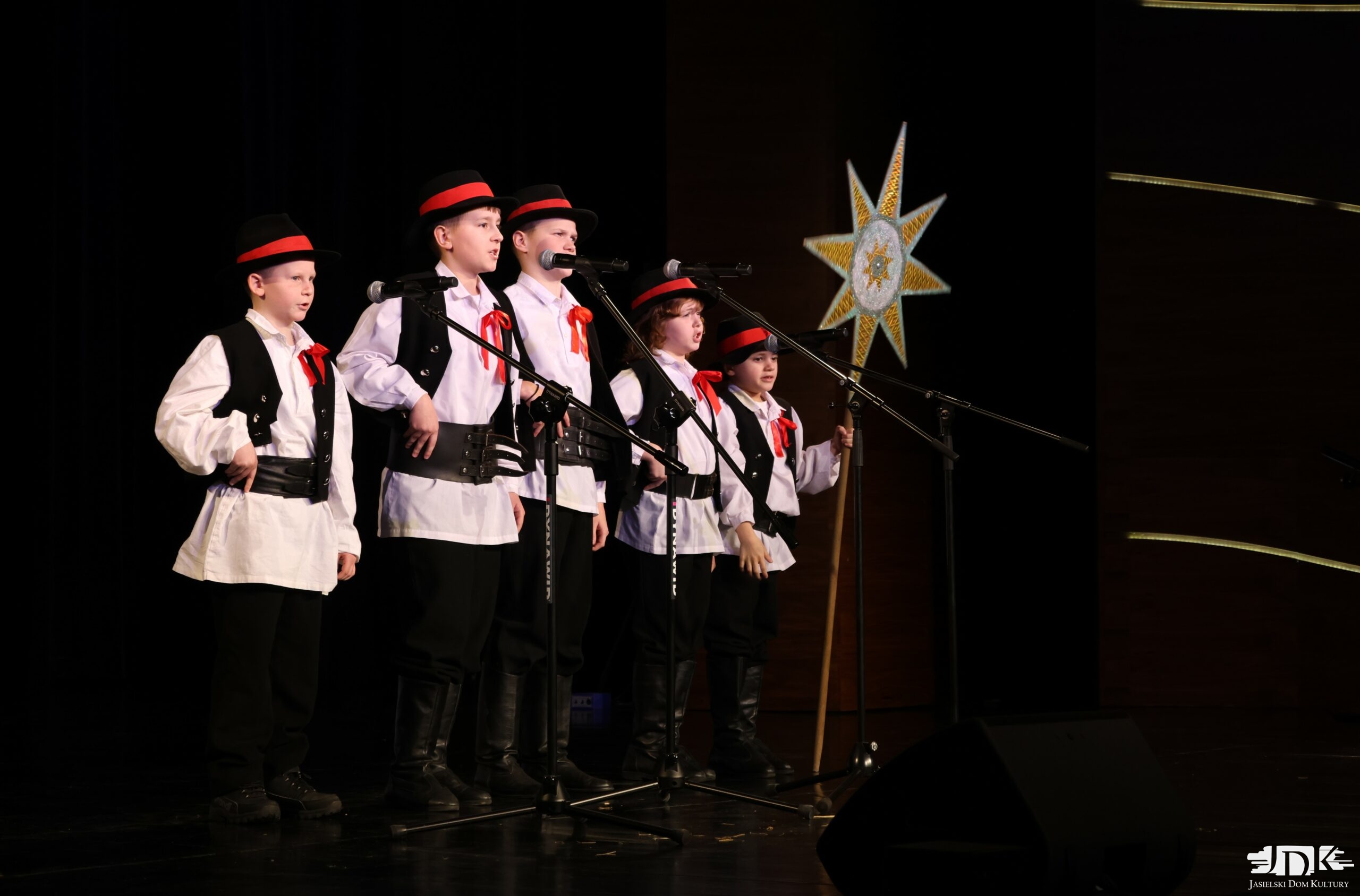 chłopięcy zespół z gwiazdą: pięciu chłopców w ludowych strojach